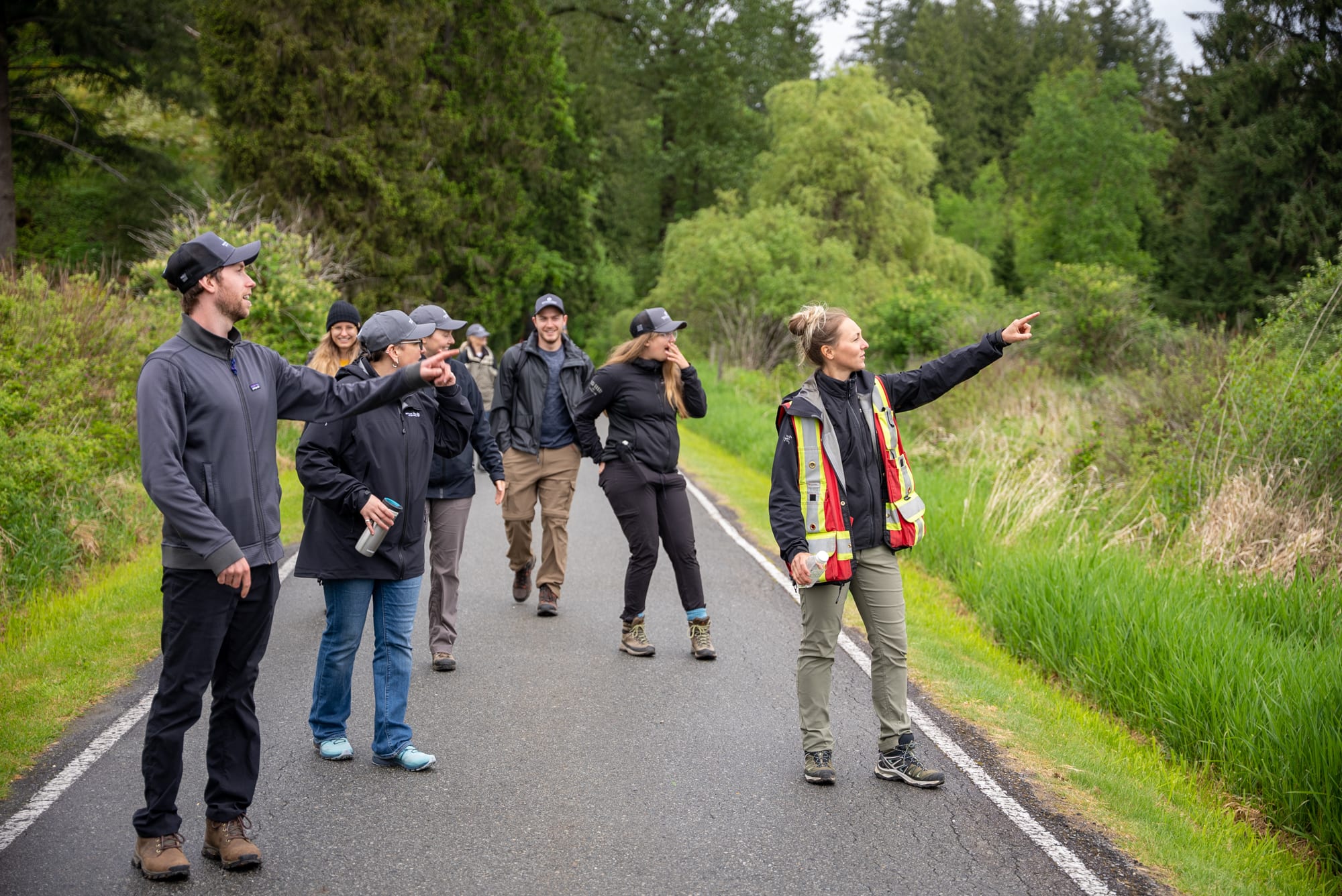 The field crew spots a bird out of frame and point towards it